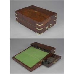 A brass bound mahogany campaign desk, with brass lifting handles, escutcheon and angle mounts, th...