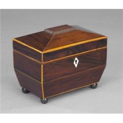 A Regency rosewood two-compartment sarcophagus tea caddy, the chamfered lid with raised gadrooned...
