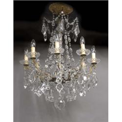 An eight-light electric chandelier, in George III style, the scrolling brass foliate branches sup...