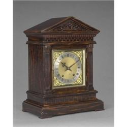 A late 19th century simulated coromandel wood mantel clock, the square brass dial with silvered R...