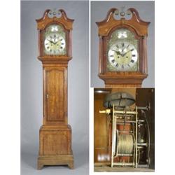 An oak longcase clock, the arched brass and silvered 30cmn dial with rococo spandrels, Roman and...