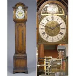An oak longcase clock, the brass 27cm dial with boys and crown spandrels, leaf chased centre and...