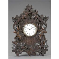 A Black Forest carved oak wall timepiece, the white enamel dial with Roman chapter ring, the 'boa...
