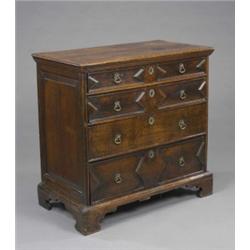 An oak chest of two short and three long drawers, geometrically moulded, brass fittings, 97cm wid...