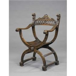 A 19th century walnut X-frame elbow chair, in Renaissance style, the cresting rail pierced with g...