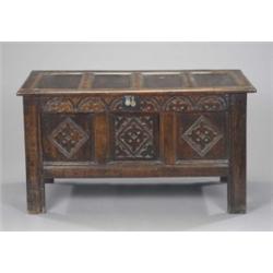 A late 17th century oak three-panel blanket chest, carved with lozenges beneath a frieze of lunet...