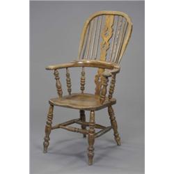 A Victorian ash high back Windsor elbow chair, with pierced splats and boldly turned supports, la...