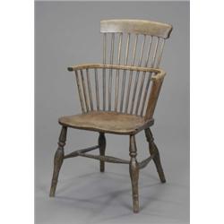 An ash comb back Windsor elbow chair, the turned legs joined by stretchers, mid-19th century 80/1...
