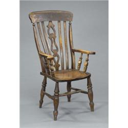 A late 19th century ash and elm high back kitchen Windsor elbow chair, with pierced splat and cur...