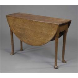 An early George III oak oval pembroke dining table, with shaped apron, the tapering legs on pad f...