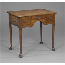 A George II oak lowboy, the moulded rectangular top above one shallow and two deep ovolo moulded...