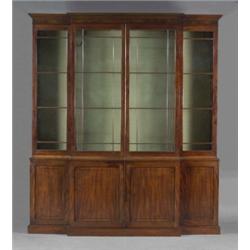 A George III mahogany breakfront library bookcase, enclosed by four astragal moulded doors glazed...