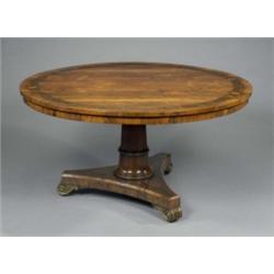 A fine Regency brass inlaid rosewood dining or centre table, the circular tilting top and incurve...