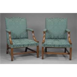 A pair of George II style mahogany Gainsborough elbow chairs, with arched stuffed-over backs, pad...