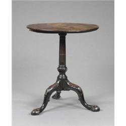 A small George II mahogany tea table, the circular top tilting on a stop-fluted and spirally vase...