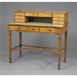 A yew serpentine writing table, in George III style, the back fitted eight shallow drawers with t...