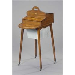 An unusual Edwardian mahogany Sheraton revival needlework table, inlaid with harewood fan and she...