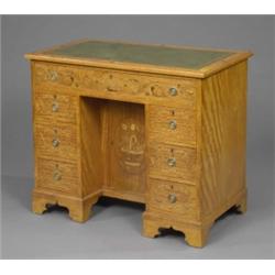 A small satinwood George III revival kneehole desk, with inset gilt stamped green leather writing...