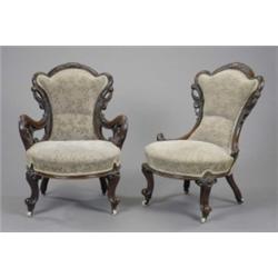 A Victorian walnut armchair and companion nursing chair, in revived rococo style, carved and pier...