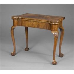 An early George II walnut folding card table, the crossbanded top with matched veneers and outset...