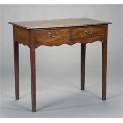 A George III mahogany rectangular side table, the moulded top above two drawers with brass loop h...