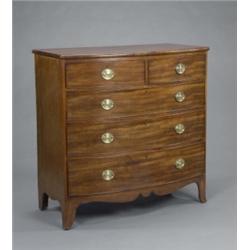 An early 19th Century mahogany bow-front chest, fitted two short and three long cockbeaded drawer...