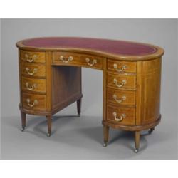 An Edwardian mahogany Sheraton revival kidney shaped pedestal desk, with inset gilt stamped red l...