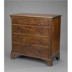A George III mahogany chest, fitted two short and three long cockbeaded drawers flanked by canted...