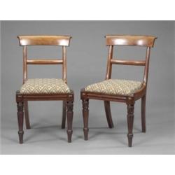 A good set of eighteen William IV mahogany dining chairs, with moulded curved oversailing crestin...