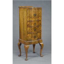 A small burr walnut block front cabinet, in George I style, with matched veneers, fitted with a t...