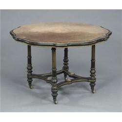 A Victorian brass mounted ebonised and gilt centre table, the shaped circular velvet lined top on...