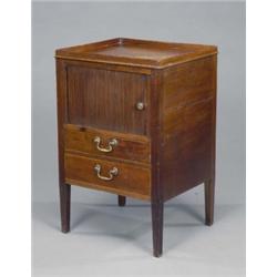 A George III mahogany bedside cabinet, the rectangular top with gallery above a tambour compartme...