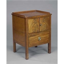 A George III mahogany bedside cabinet, with three-quarter gallery above a pair of curl veneered d...