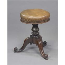 A Victorian rosewood piano stool, the circular seat adjusting on a lotus turned pillar and cabrio...