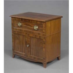 A mahogany cabinet, part George III, fitted with a deep panelled drawer above a pair of panelled...
