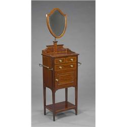 An Edwardian mahogany Sheraton revival shaving stand, the adjustable shield shaped bevelled mirro...