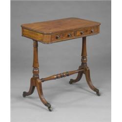 A small early 19th century mahogany sofa table, the reeded rounded rectangular top above a shallo...