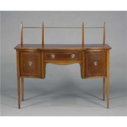 An Edwardian mahogany Sheraton revival breakfront serpentine sideboard, the brass railed gallery...