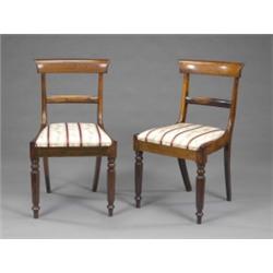 A set of four early Victorian faux rosewood dining chairs, with curved oversailing cresting rails...