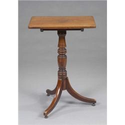 An early Victorian mahogany occasional table, the rectangular top tilting on a turned pillar and...