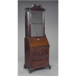 A small mahogany bureau-bookcase, part George II, enclosed by a bevelled glazed two-panel door be...
