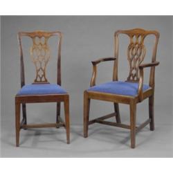 A set of six mahogany dining chairs, in George II style, with serpentine cresting rails and pierc...