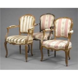 Three stained beechwood elbow chairs, in Louis XVI Transitional style, the moulded undulating fra...