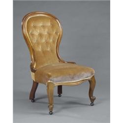 A Victorian mahogany spoon-back nursing chair, of plain design, on scroll legs, upholstered in bu...