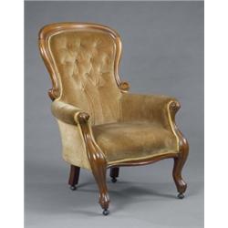 A Victorian mahogany spoon-back armchair, with serpentine seat and scroll moulded arms and legs,...