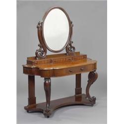 A Victorian mahogany shaped front dressing table, the oval mirror with pierced supports above thr...