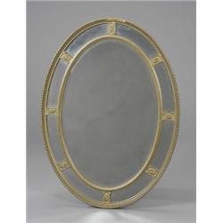 An Edwardian gilt oval wall mirror, in George III style, the bevelled centre plate within beaded...