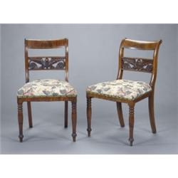 A set of four Regency mahogany dining chairs, the tie-rails pierced and carved with acorns, acant...