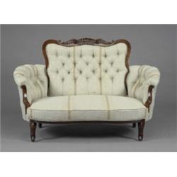 A Victorian mahogany two-seat salon sofa, stuffed-over seat, curved arms and shaped back in butto...
