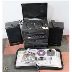 TEAL CD STEREO WITH BINDER OF CDS.